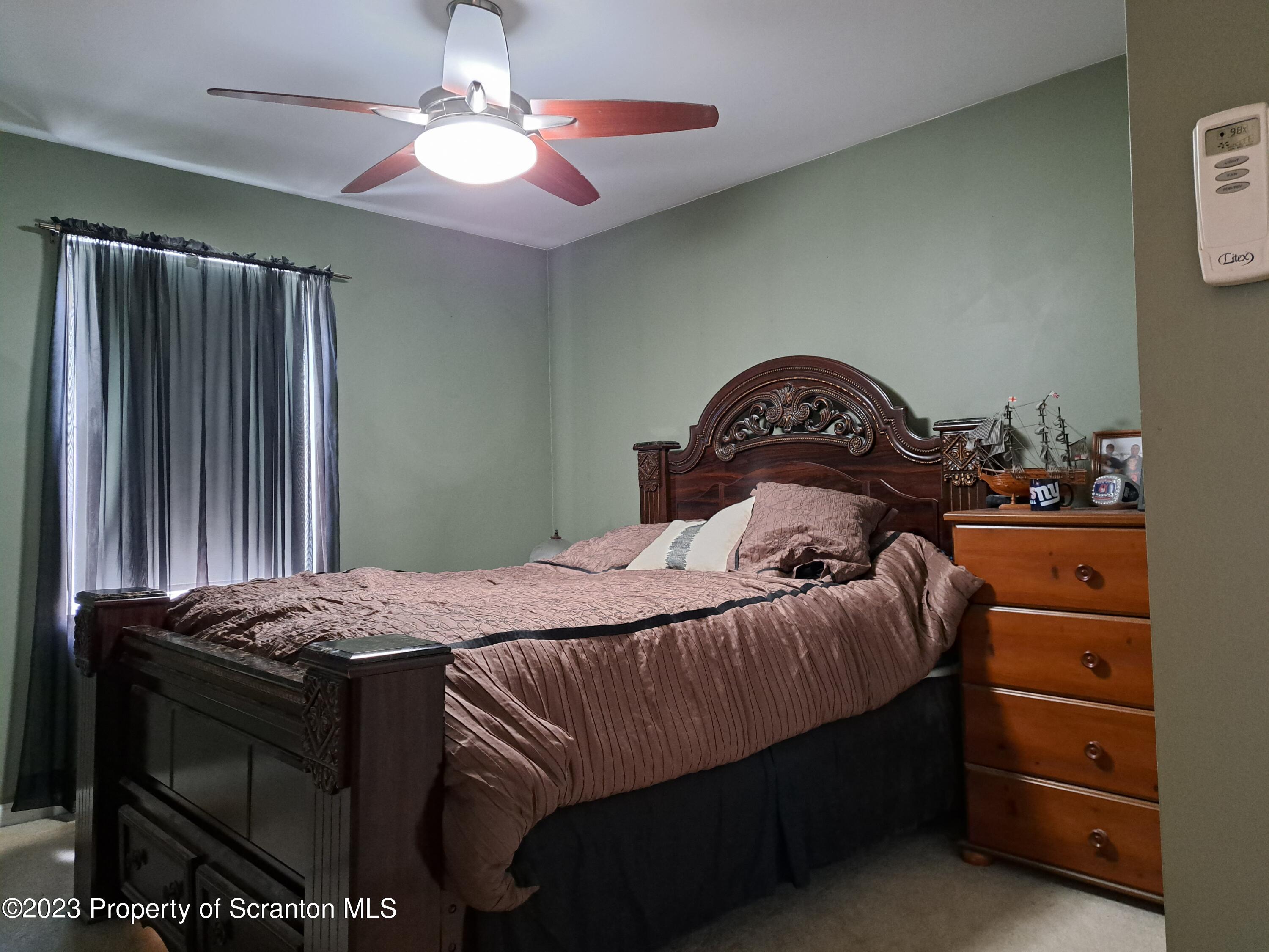 987 Chase Road Shavertown, PA 18708 - Photo 49 of 70 a bedroom with a bed and a chandelier