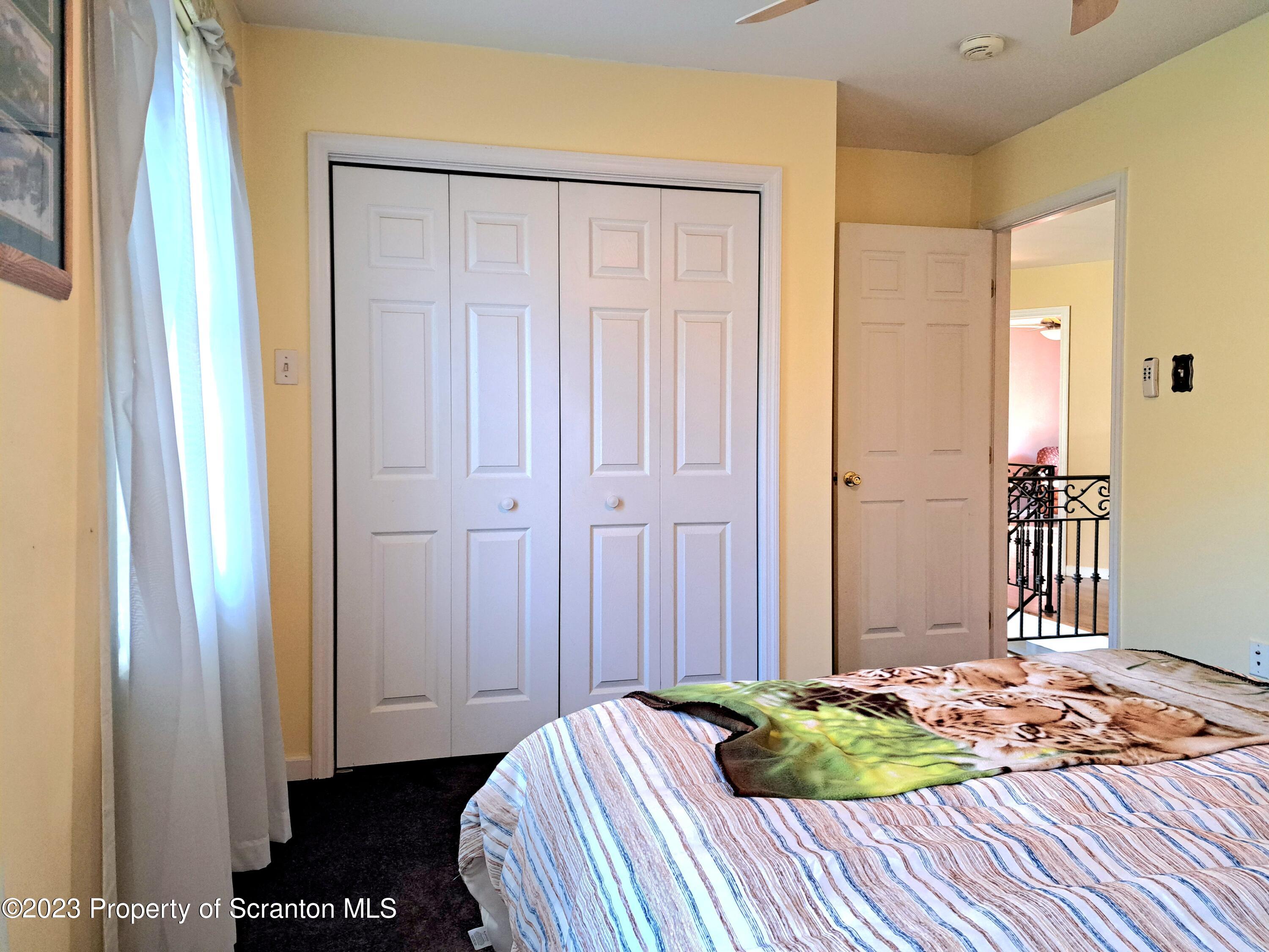 987 Chase Road Shavertown, PA 18708 - Photo 51 of 70 a bedroom with a bed and a mirror