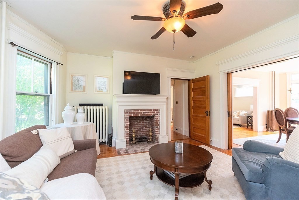 265 Water Street Clinton, MA 01510 - Photo 12 of 30 a living room with furniture a fireplace and a large window