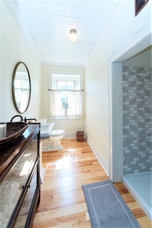 265 Water Street Clinton, MA 01510 - Photo 13 of 30 a living room with a sink a mirror and a rug
