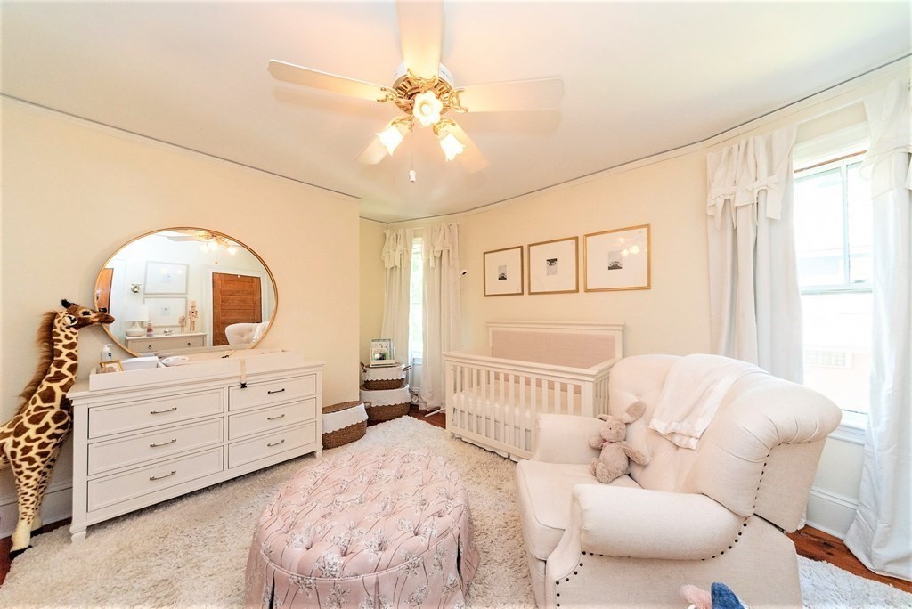 265 Water Street Clinton, MA 01510 - Photo 18 of 30 a bedroom with a bed and a chandelier