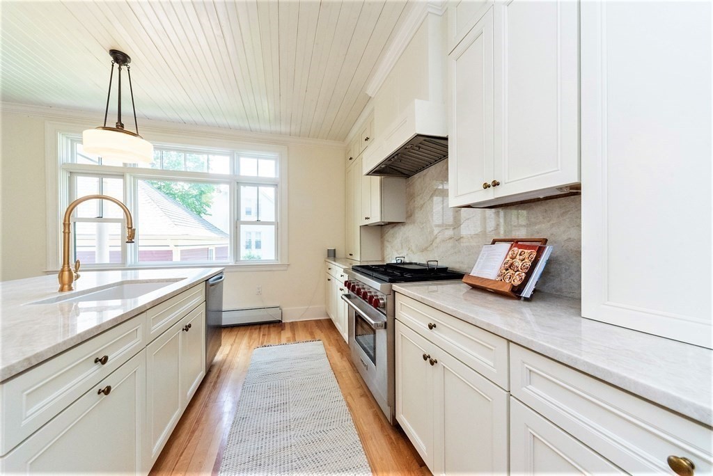 265 Water Street Clinton, MA 01510 - Photo 7 of 30 a kitchen with a sink stove and cabinets