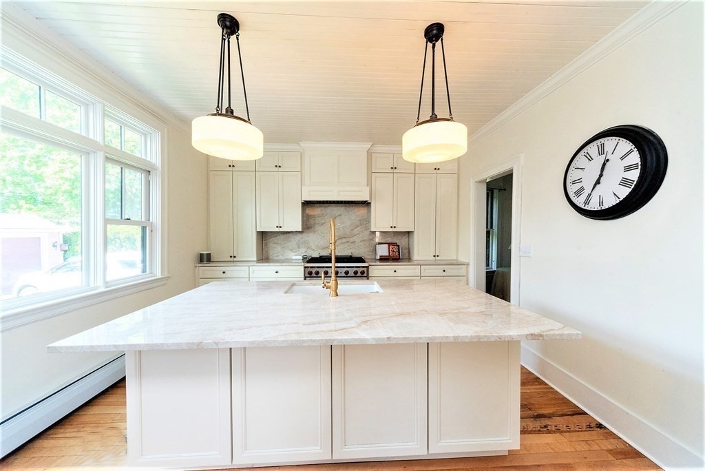 265 Water Street Clinton, MA 01510 - Photo 8 of 30 a kitchen with a table and a chandelier
