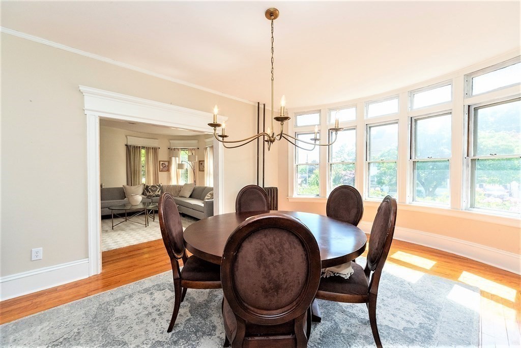 265 Water Street Clinton, MA 01510 - Photo 10 of 30 a dining room with furniture a chandelier and wooden floor