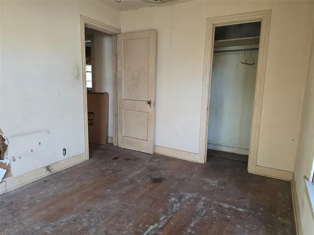 an empty room with closet area