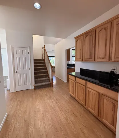 a kitchen with wooden floors and a sink