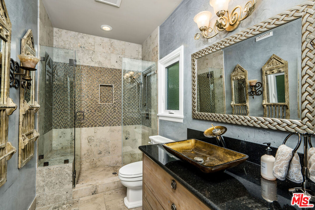 204 Bell Cyn Road Bell Canyon, CA 91307 - Photo 25 of 75 a bathroom with a sink a toilet a mirror and shower