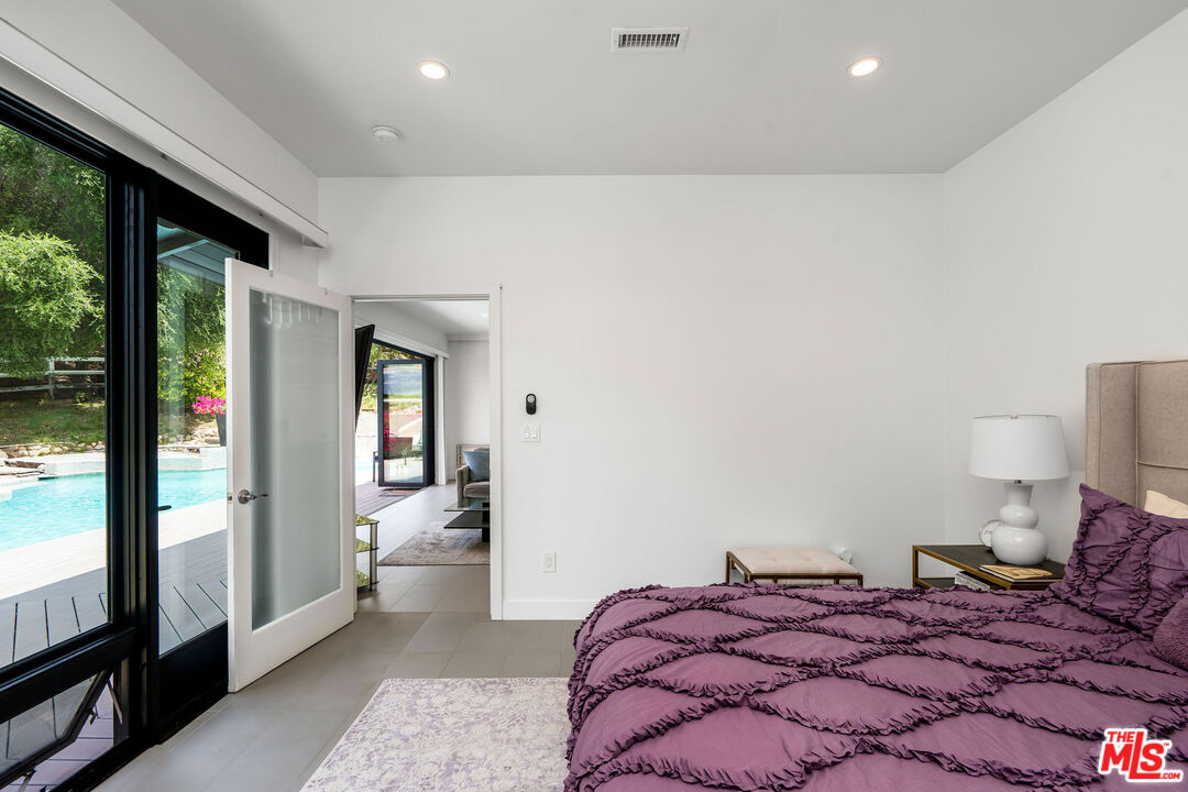 204 Bell Cyn Road Bell Canyon, CA 91307 - Photo 57 of 75 a bedroom with a large bed and a large window