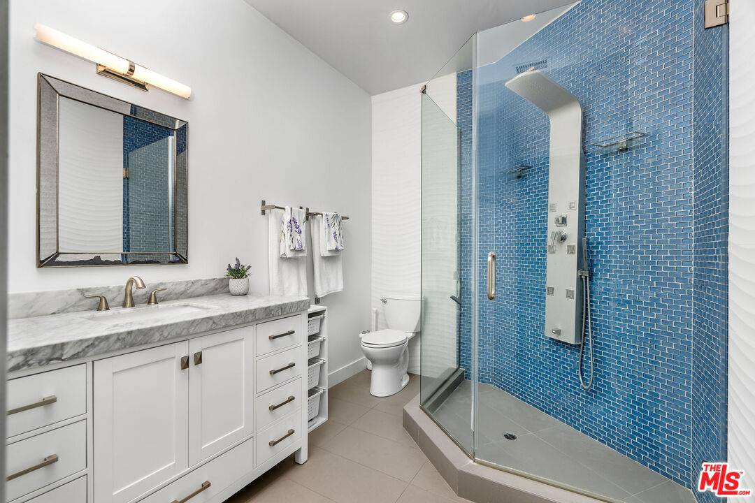 204 Bell Cyn Road Bell Canyon, CA 91307 - Photo 58 of 75 a bathroom with a granite countertop toilet a sink and a mirror