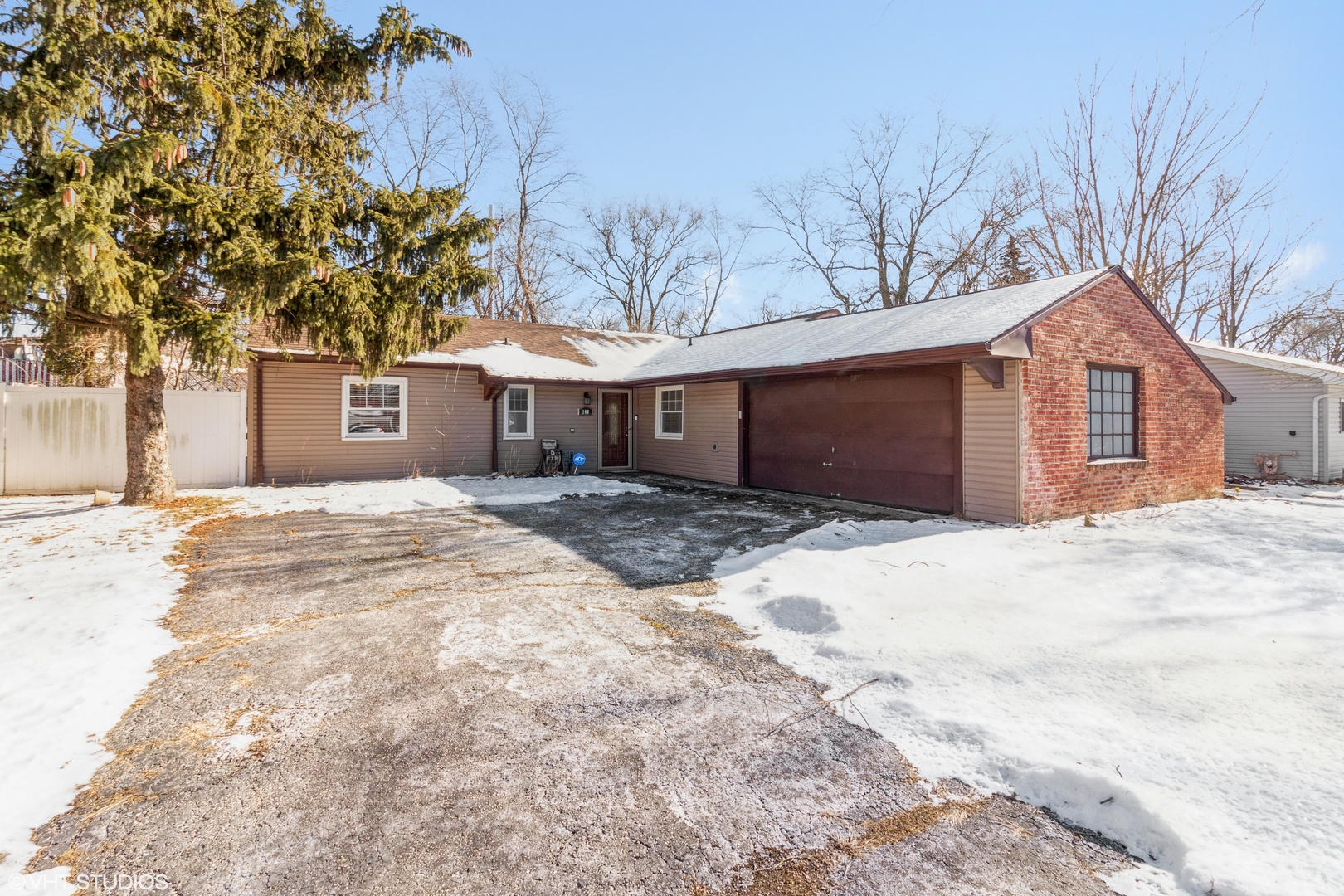 168 North Pinecrest Road Bolingbrook, IL 60440 - Photo 1 of 15 a front view of a house with a yard covered in snow