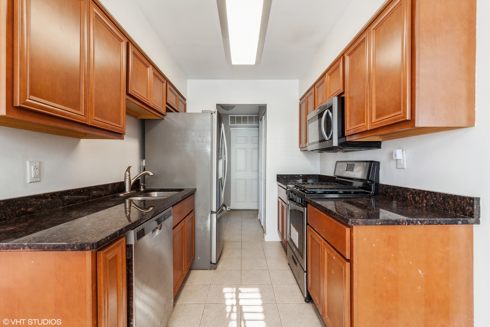 168 North Pinecrest Road Bolingbrook, IL 60440 - Photo 5 of 15 a kitchen with stainless steel appliances granite countertop a stove a sink and a refrigerator