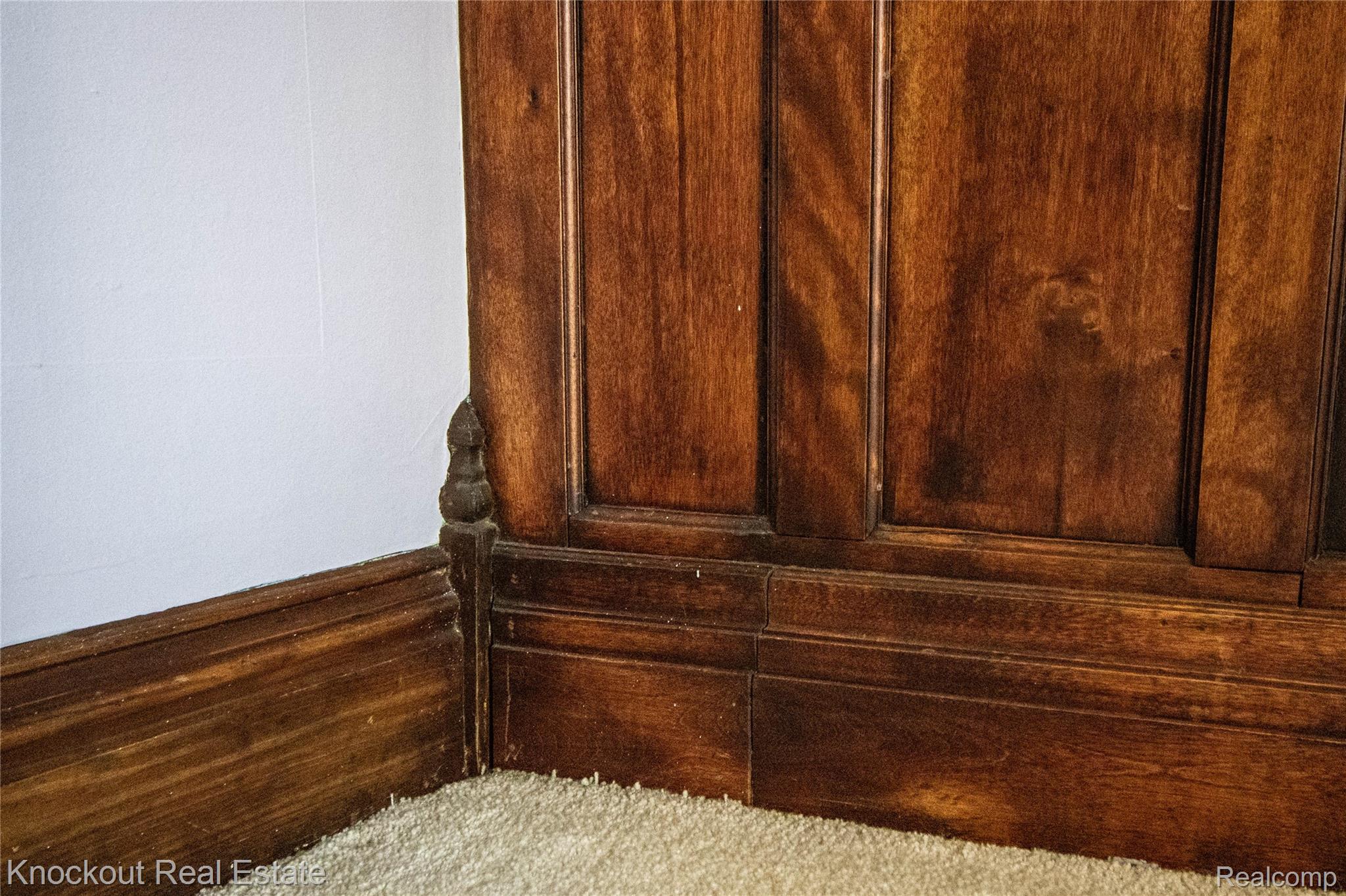 19983 West Ridge Road Henderson, MI 48841 - Photo 23 of 76 Dark wood paneling with intricate molding and carved newel post detail