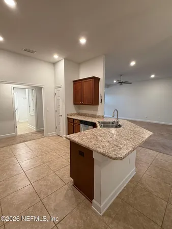 a large kitchen with cabinets a sink and a stove