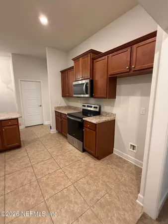a kitchen with stainless steel appliances granite countertop a sink and cabinets