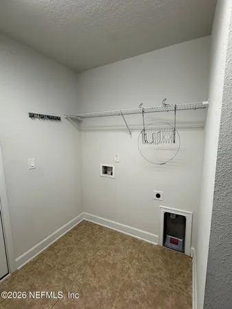 an empty room with a ceiling fan and windows