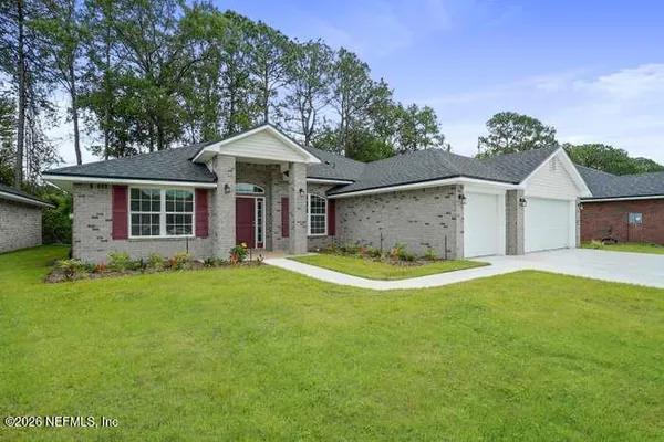 a view of a house with a backyard