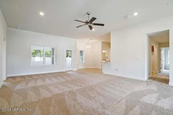 an empty room with windows and entrance