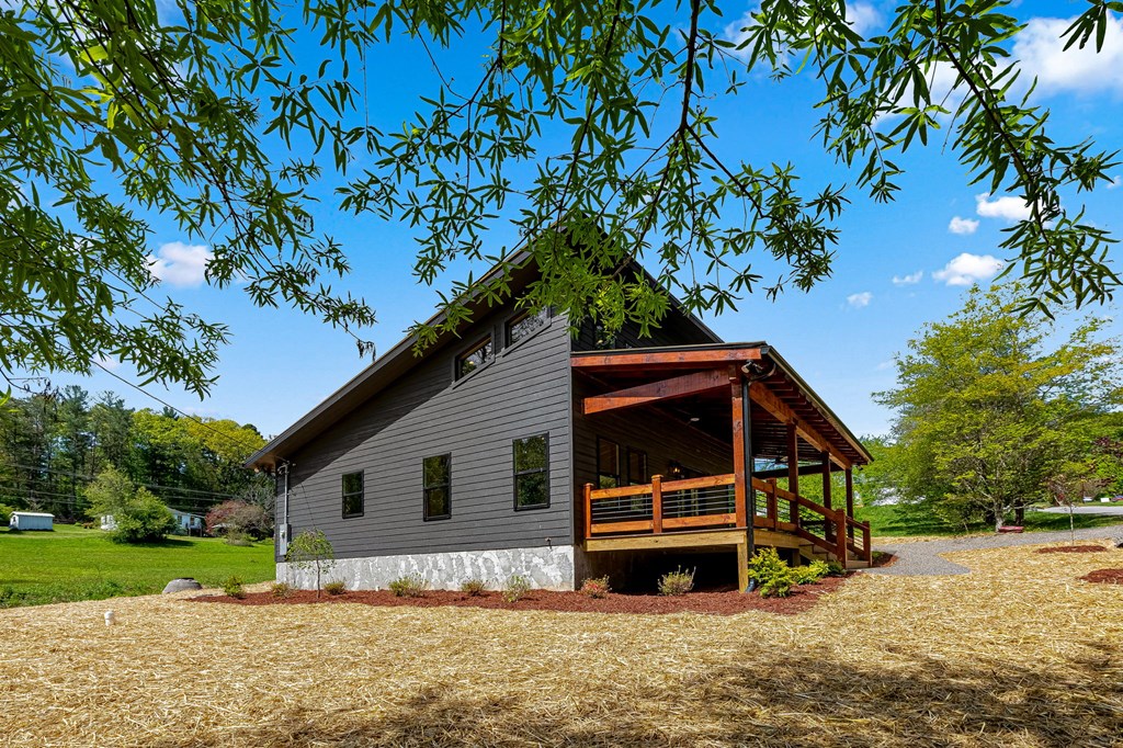 168 Ewing Street Blue Ridge, GA 30513 - Photo 2 of 46 a house view with a garden space
