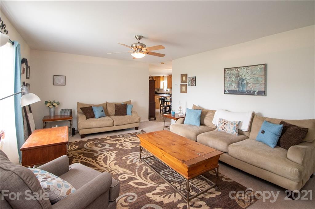 4417 Medlin Road Monroe, NC 28112 - Photo 11 of 30 a living room with furniture a rug and a window