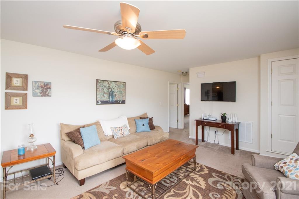 4417 Medlin Road Monroe, NC 28112 - Photo 12 of 30 a living room with furniture and a flat screen tv