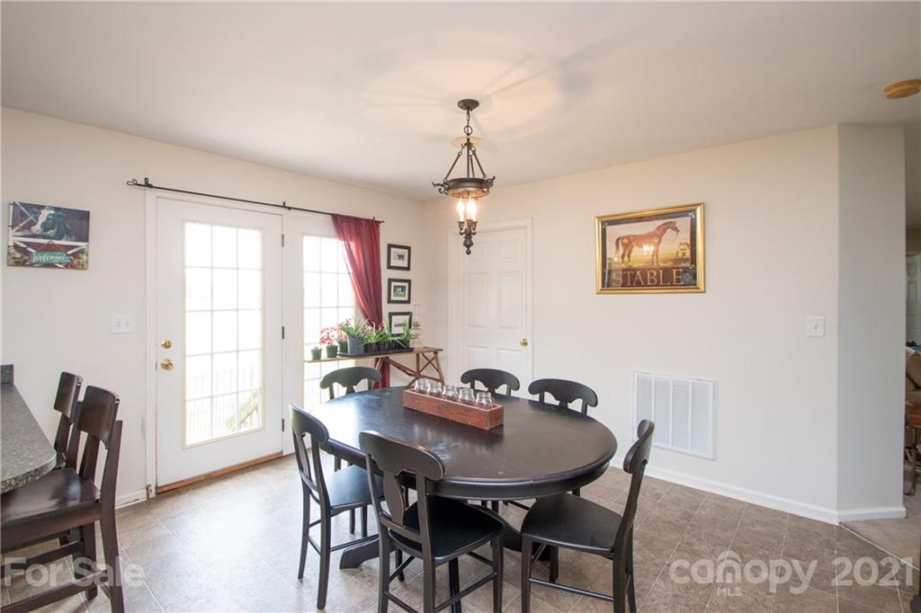 4417 Medlin Road Monroe, NC 28112 - Photo 14 of 30 a view of a dining room with furniture window and wooden floor
