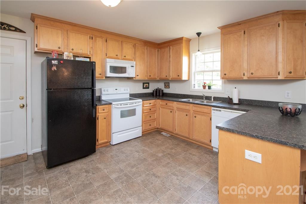 4417 Medlin Road Monroe, NC 28112 - Photo 16 of 30 a kitchen with a sink stove and refrigerator