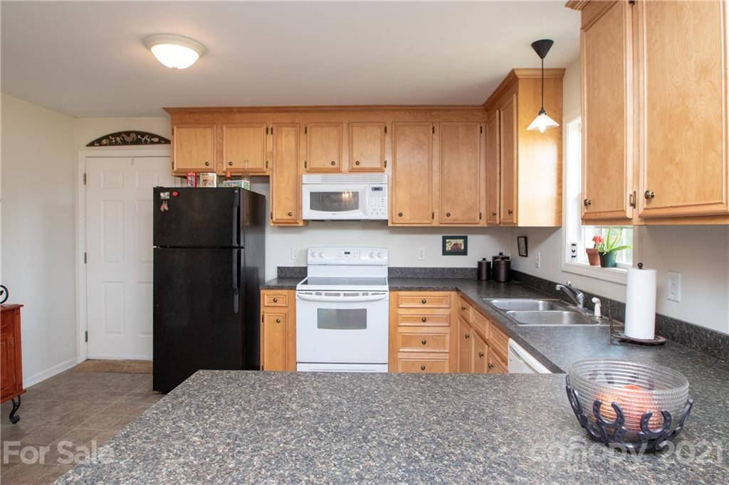 4417 Medlin Road Monroe, NC 28112 - Photo 17 of 30 a kitchen with stainless steel appliances granite countertop a refrigerator sink and stove