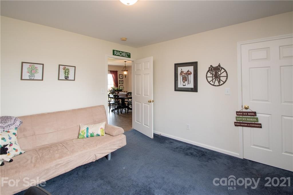 4417 Medlin Road Monroe, NC 28112 - Photo 21 of 30 a living room with furniture and wall paintings