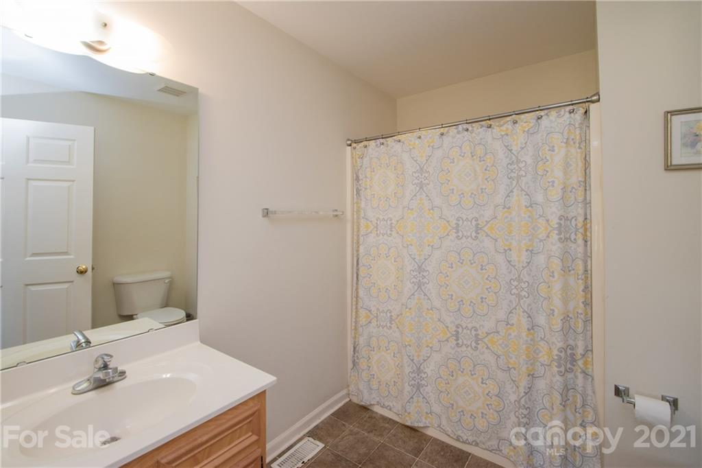 4417 Medlin Road Monroe, NC 28112 - Photo 22 of 30 a bathroom with a sink and a mirror