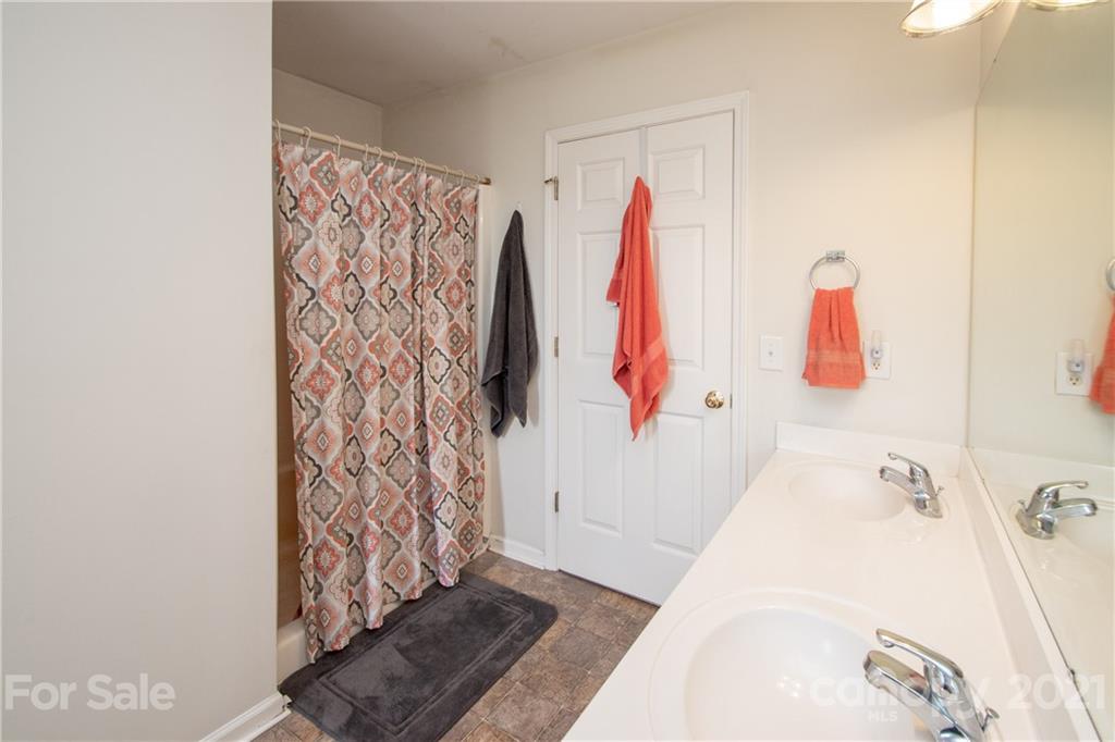 4417 Medlin Road Monroe, NC 28112 - Photo 28 of 30 a bathroom with a bathtub and shower curtain