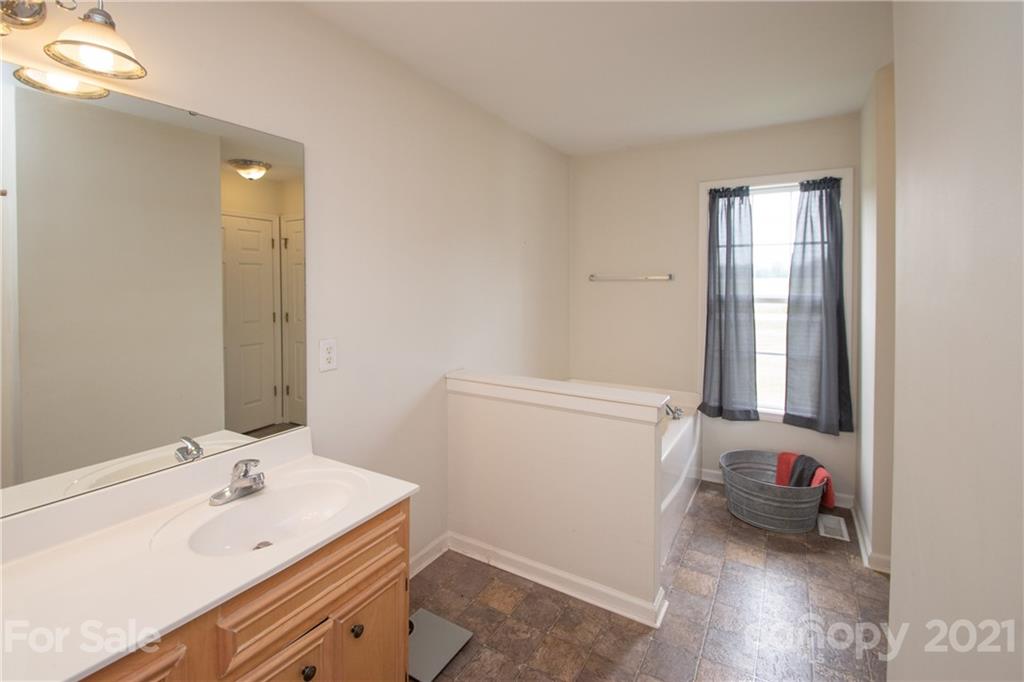 4417 Medlin Road Monroe, NC 28112 - Photo 29 of 30 a bathroom with a sink and a mirror