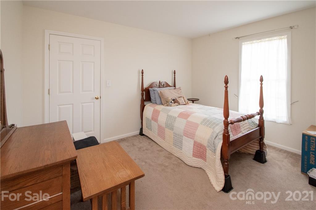 4417 Medlin Road Monroe, NC 28112 - Photo 30 of 30 a bedroom with a bed and a table in it