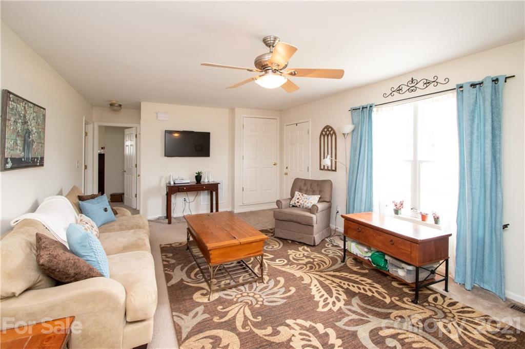 4417 Medlin Road Monroe, NC 28112 - Photo 10 of 30 a living room with furniture and a flat screen tv