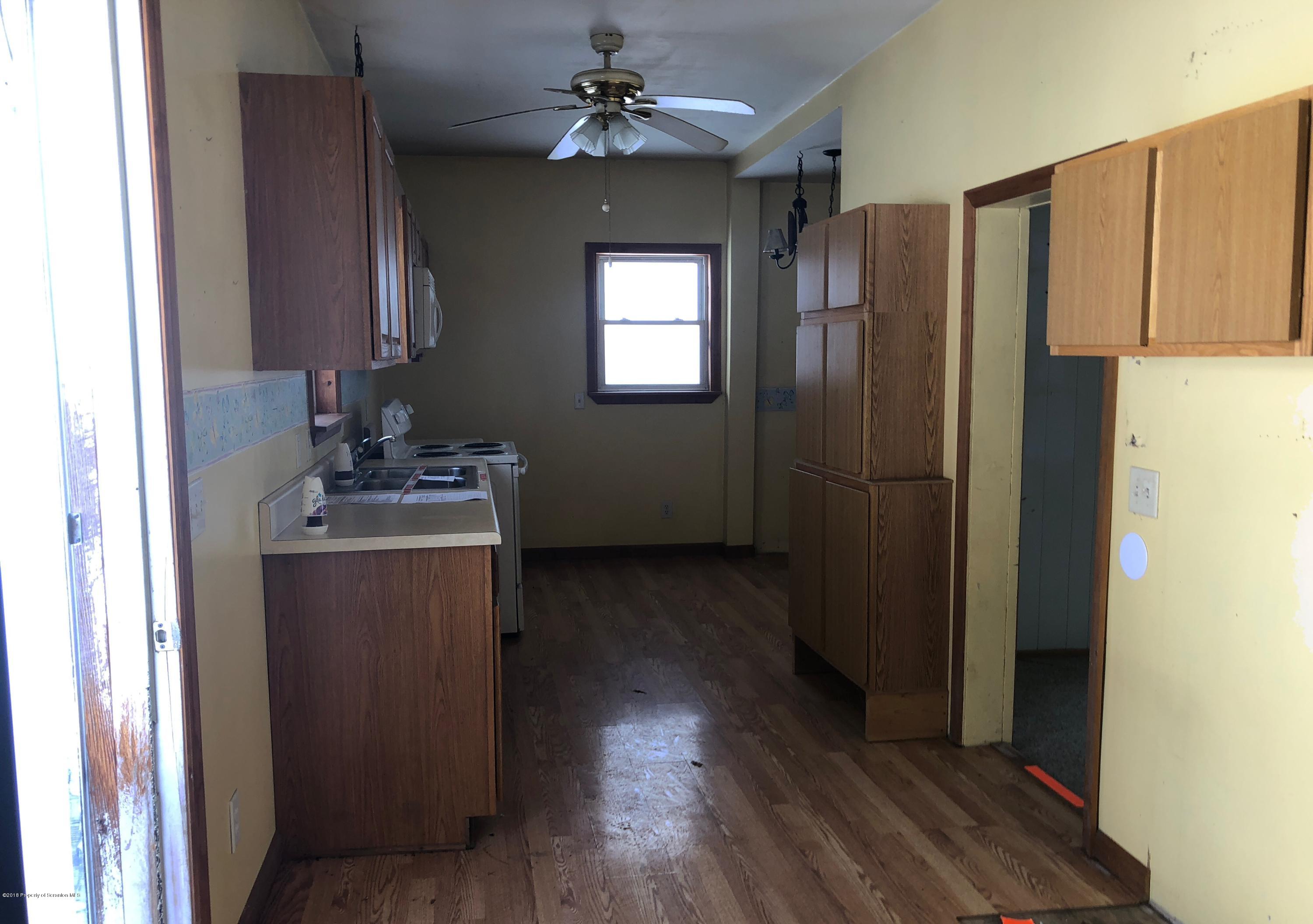 106 Browntown Road Wyalusing, PA 18853 - Photo 2 of 11 a kitchen with kitchen island wooden floors appliances and furniture