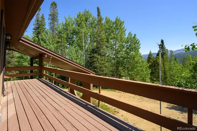 a view of balcony with wooden floor and fence