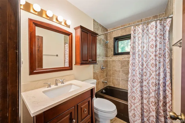 a bathroom with a sink toilet a mirror and shower