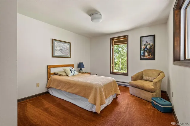 a bedroom with a bed couch and a window