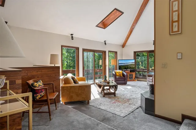 a living room with furniture and large windows