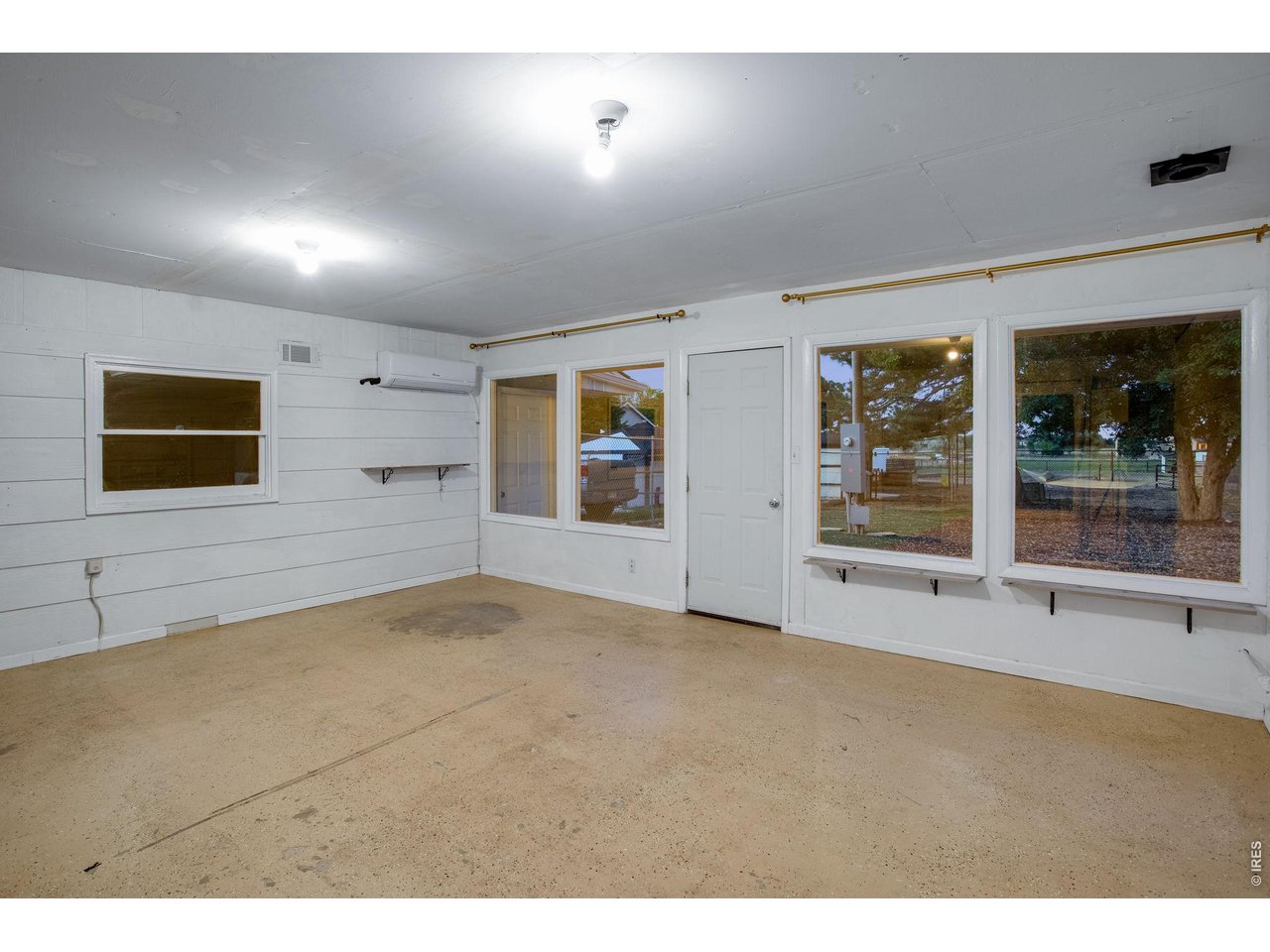 5416 South Timberline Road Fort Collins, CO 80528 - Photo 36 of 50 Breezeway between garage and home features front and back patio access and a mini split for cooling. Perfect place for a gym, yoga, party, craft or office