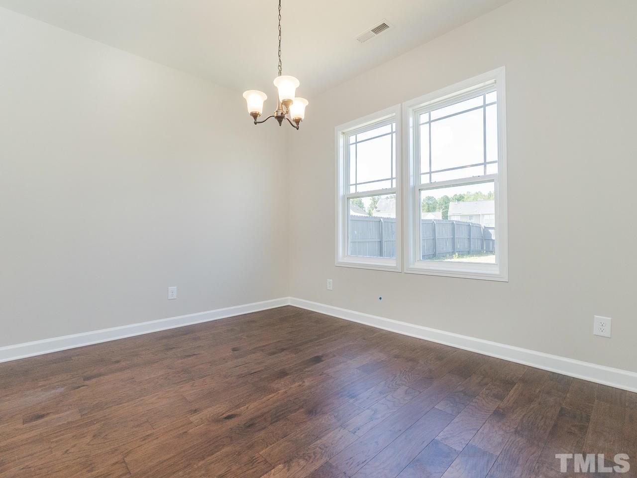 3958 Patriot Ridge Court Raleigh, NC 27610 - Photo 11 of 28 a view of empty room with wooden floor and fan