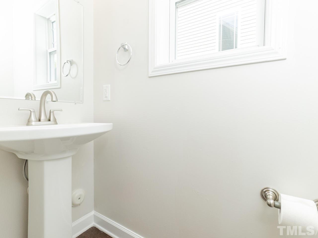 3958 Patriot Ridge Court Raleigh, NC 27610 - Photo 13 of 28 a bathroom with a sink and a mirror