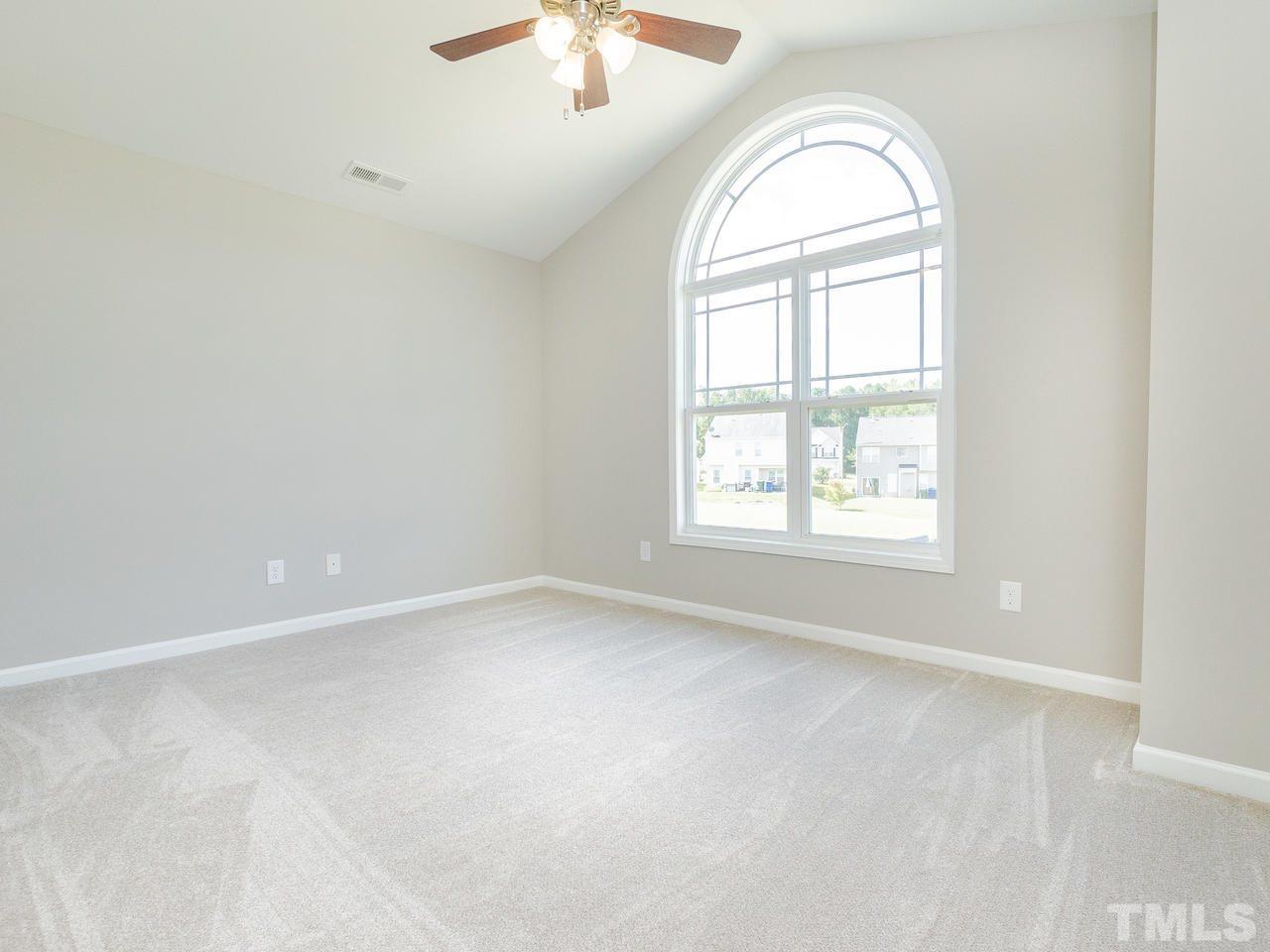 3958 Patriot Ridge Court Raleigh, NC 27610 - Photo 15 of 28 an empty room with windows and chandelier fan