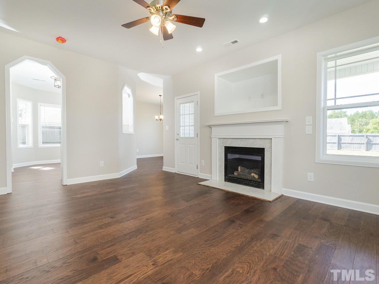 3958 Patriot Ridge Court Raleigh, NC 27610 - Photo 3 of 28 a view of an empty room with wooden floor and a window