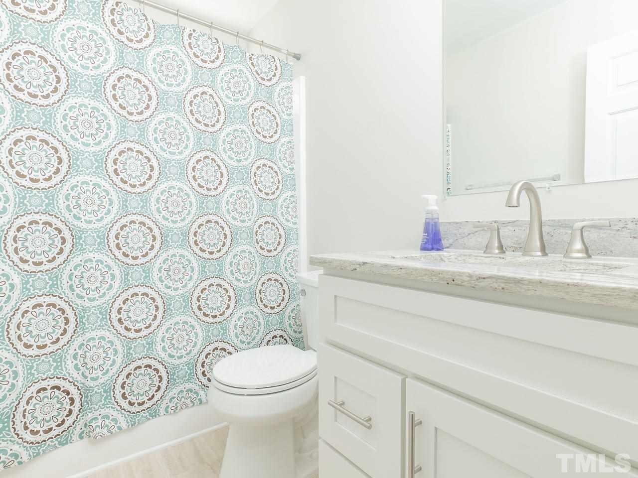 3958 Patriot Ridge Court Raleigh, NC 27610 - Photo 22 of 28 a bathroom with a toilet and a sink