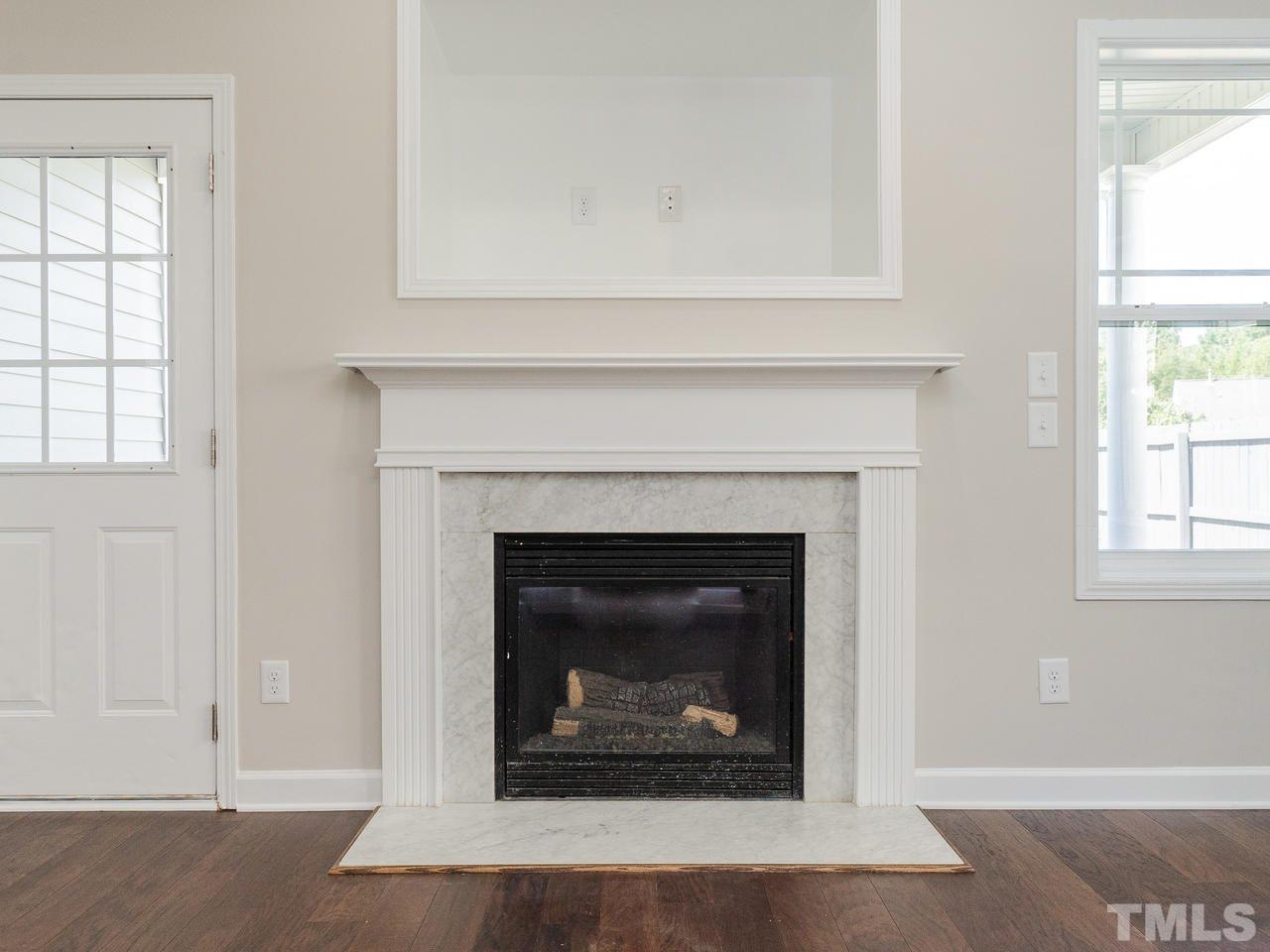 3958 Patriot Ridge Court Raleigh, NC 27610 - Photo 4 of 28 a living room with a fireplace