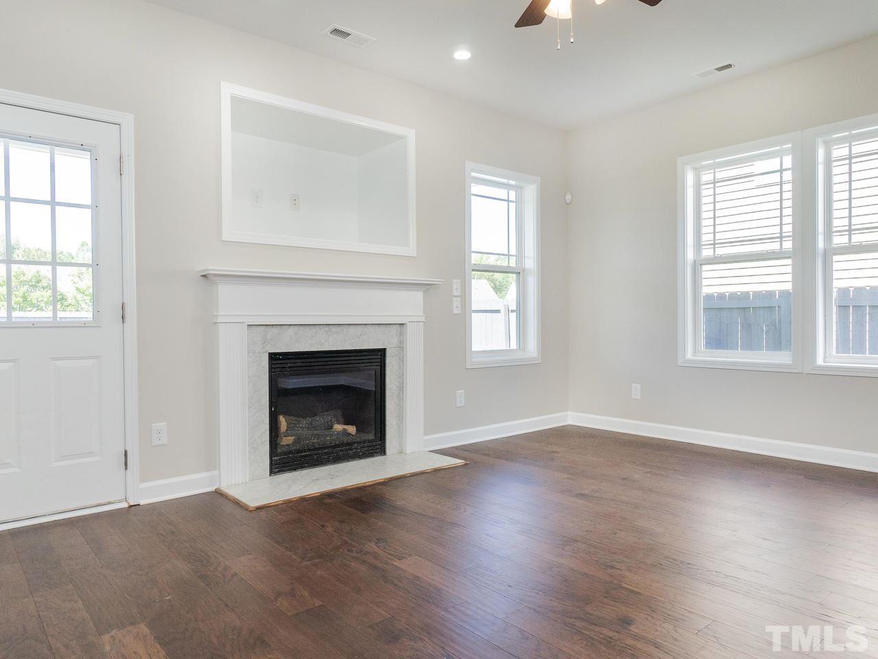 3958 Patriot Ridge Court Raleigh, NC 27610 - Photo 5 of 28 an empty room with windows and a fireplace