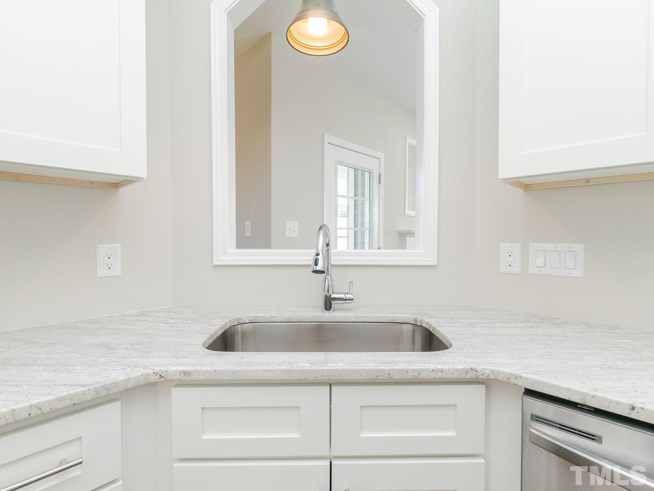 3958 Patriot Ridge Court Raleigh, NC 27610 - Photo 9 of 28 a kitchen with sink and cabinets