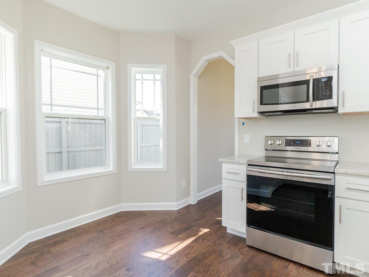 3958 Patriot Ridge Court Raleigh, NC 27610 - Photo 10 of 28 a kitchen with cabinets stainless steel appliances and a window