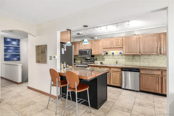 a kitchen with stainless steel appliances granite countertop a sink and cabinets