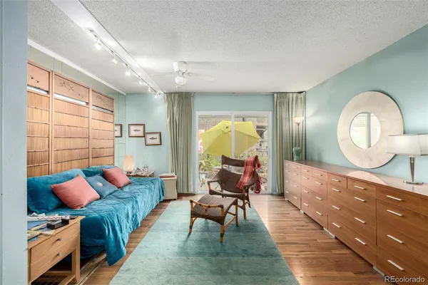 a living room with furniture and a mirror